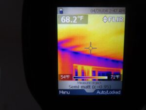 A thermal imaging screen showing temperature variations. The display shows a measurement of 68.2°F, with hot spots around 71°F and colder areas around 54°F. The date displayed is 04/28/04, time 2:47 AM.